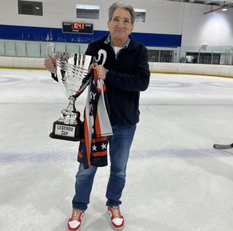 Michael Litsky at the rink holding the Legends Cup